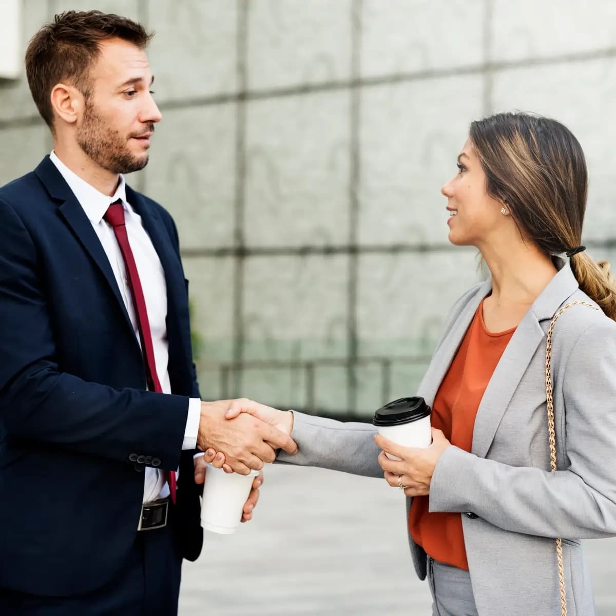 Corporate handshake between real estate professionals closing a deal